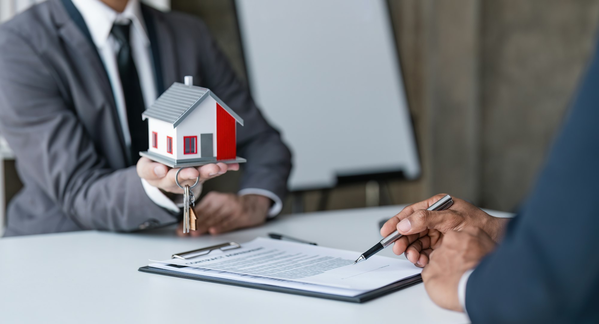 Real estate broker agent presenting and consult to customer to decision making sign insurance form